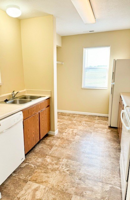 A kitchen with a washer and dryer in it.