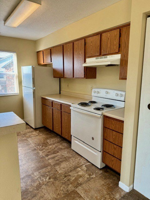 a kitchen with a stove and a refrigerator