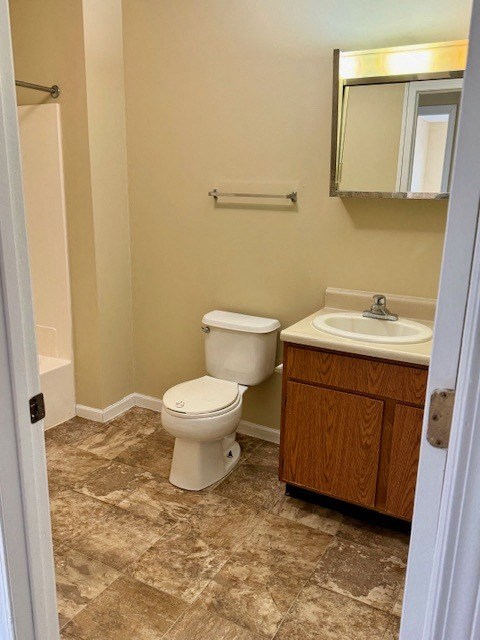 a bathroom with a toilet a sink and a mirror