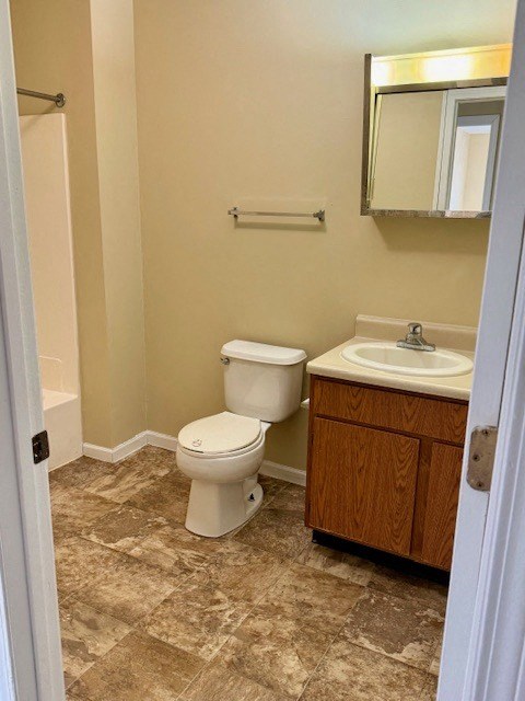 a bathroom with a toilet a sink and a mirror