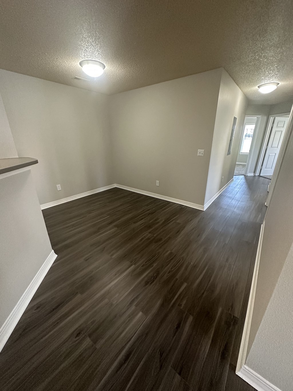 an empty room with a hardwood floor