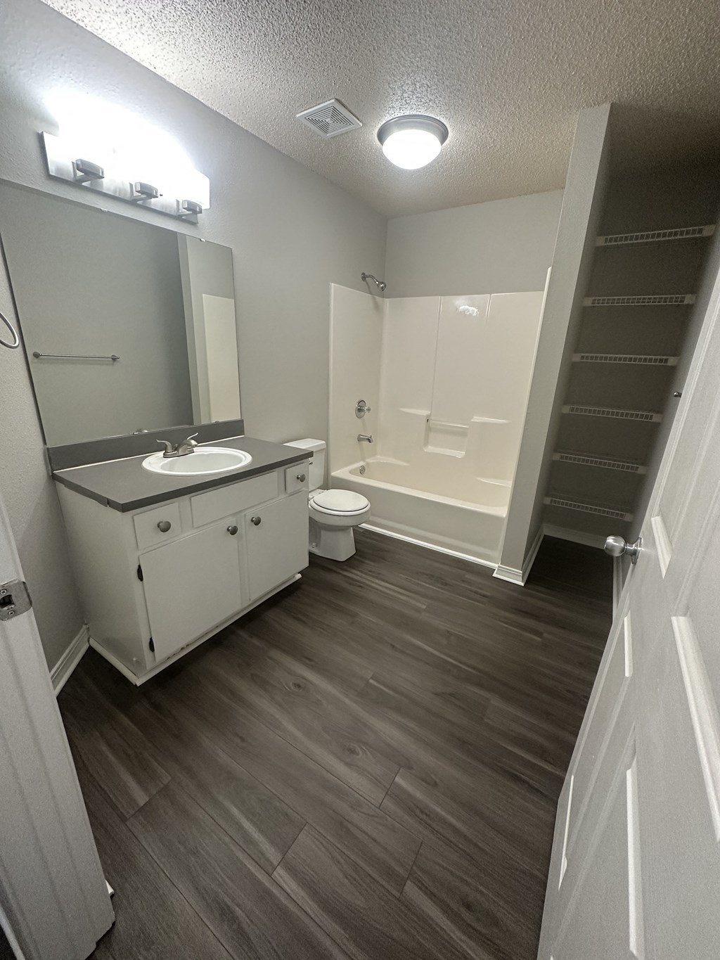 an empty bathroom with a sink toilet and bathtub