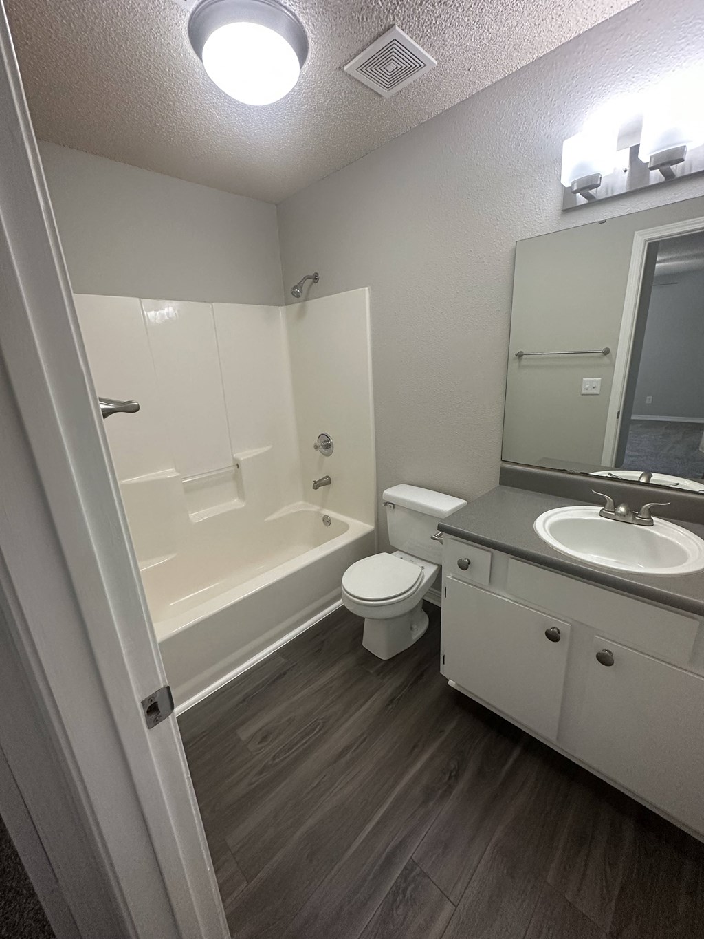 an empty bathroom with a toilet sink and bathtub