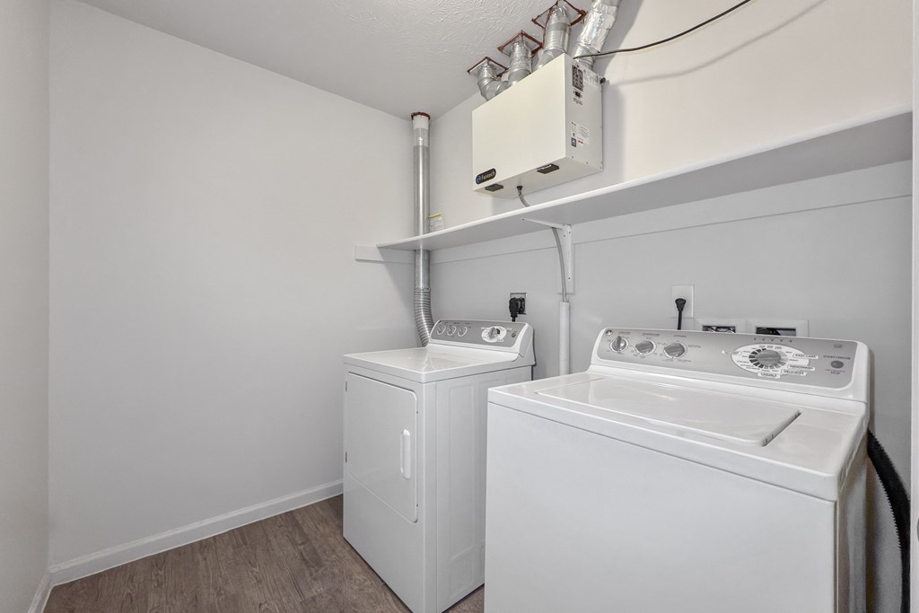 A white washing machine and dryer in a small laundry room.