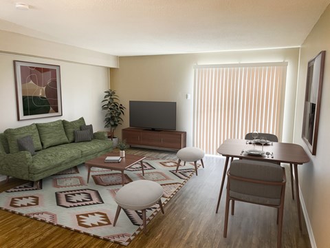 A living room with a green couch, a wooden table, and a television.