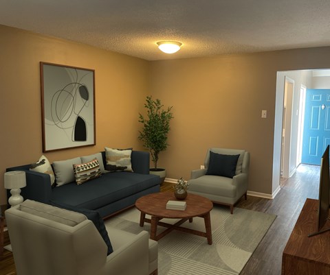 A living room with a blue couch, a grey armchair, a wooden coffee table, and a painting on the wall.