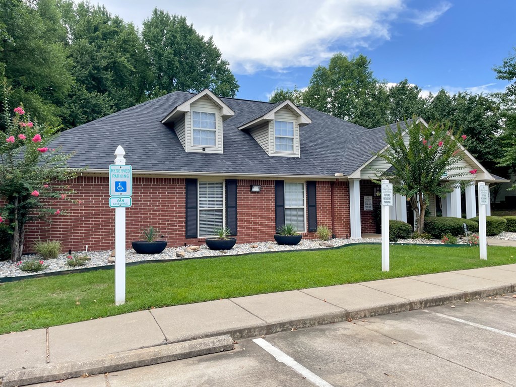 A house with a blue sign in front of it.