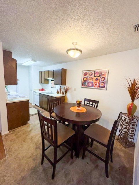 A dining room with a table set for four.