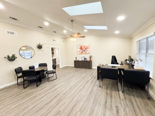 A room with a table and chairs and a mirror on the wall.