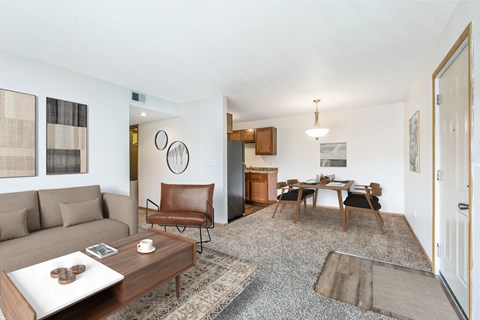 A living room with a brown chair and a brown couch.