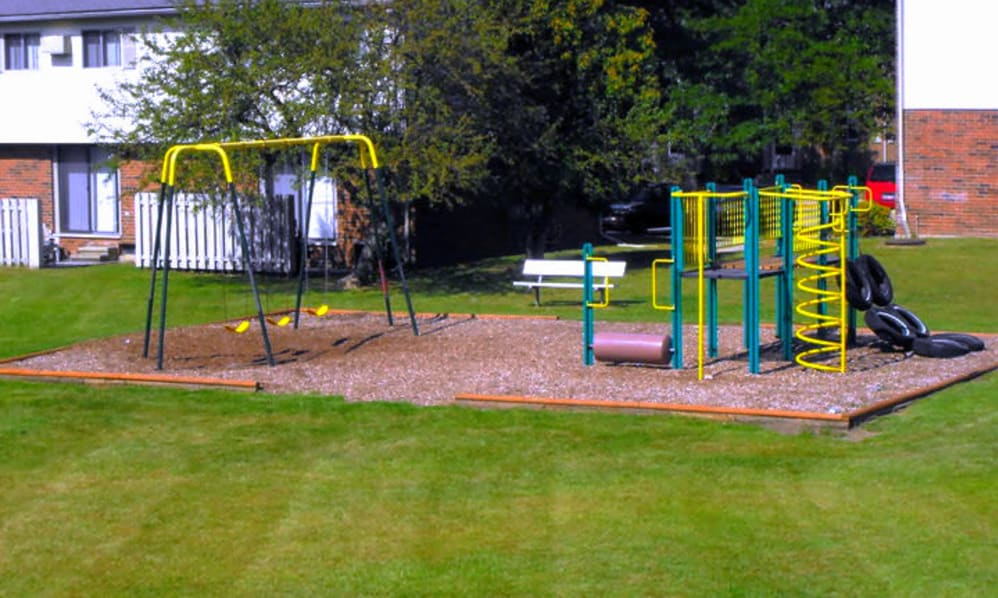 a playground with a swing set in a yard
