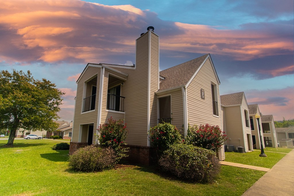 a row of houses with a cloudy sky in the background
