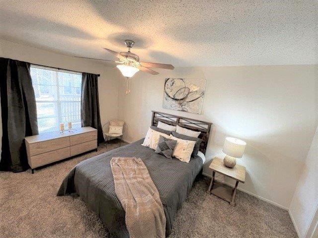 a bedroom with a bed and a ceiling fan