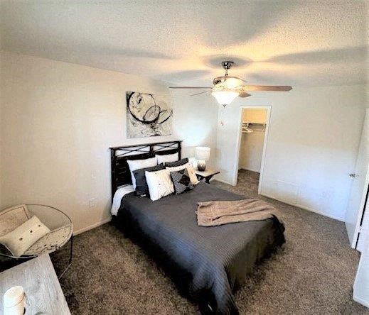a bedroom with a bed and a ceiling fan