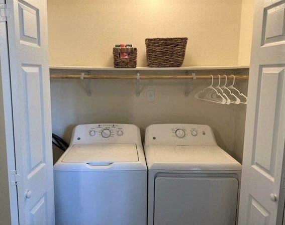 two washing machines in a small laundry room