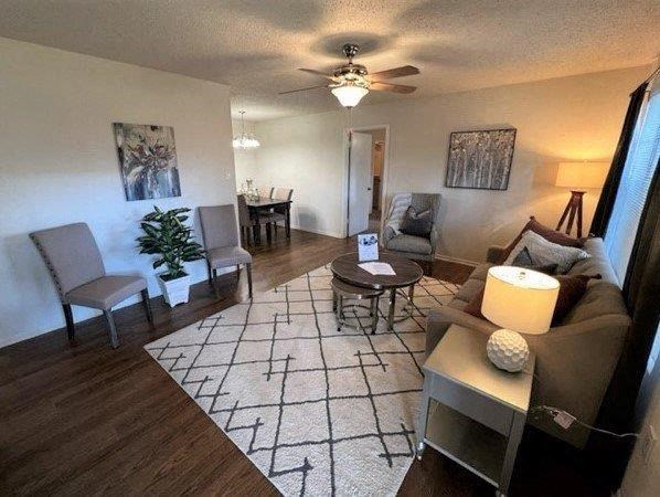 a living room with a couch and a ceiling fan