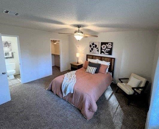 a bedroom with a bed and a ceiling fan