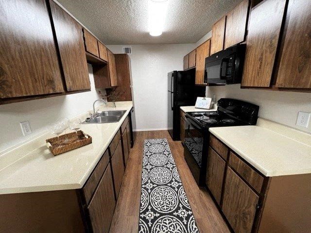 a kitchen with a rug in the middle