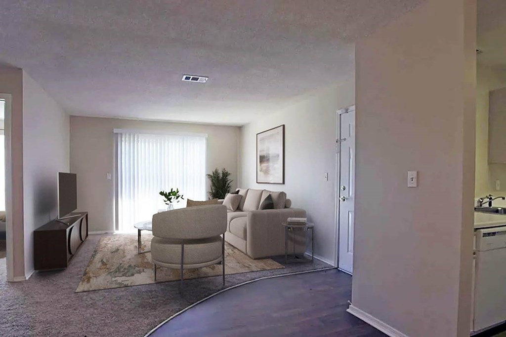 A living room with a couch, chair, and television.