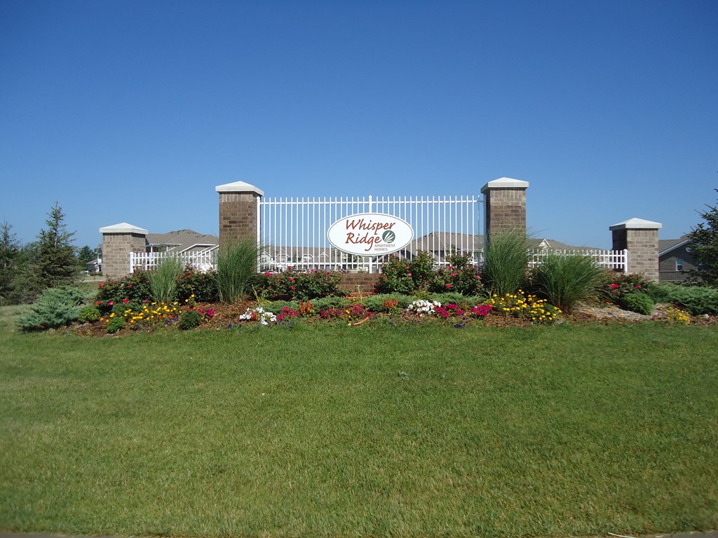A sign that says "Windsor Ridge" is on a gate.