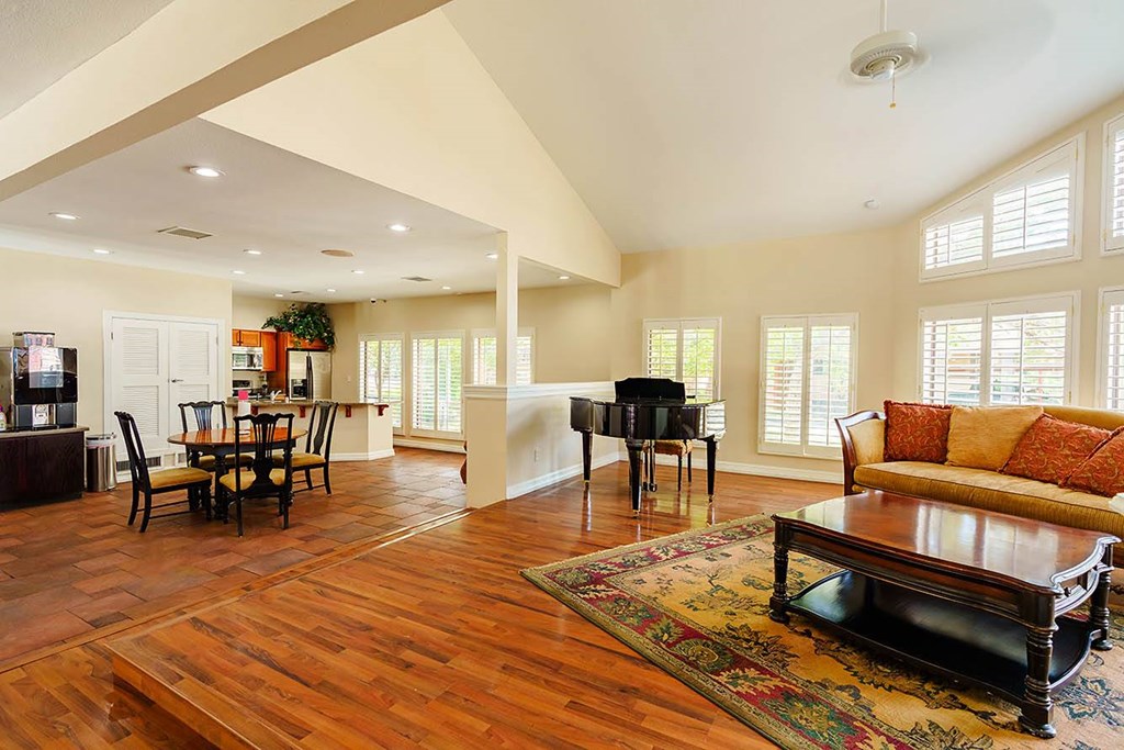 A living room with a piano and a couch.