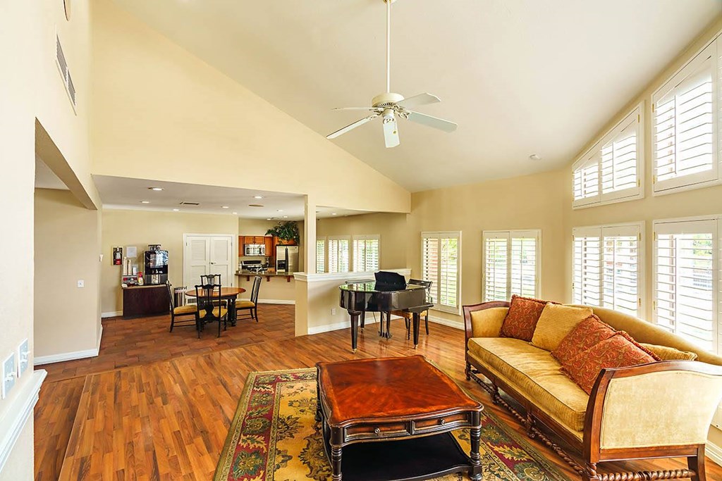 A living room with a piano and a couch.