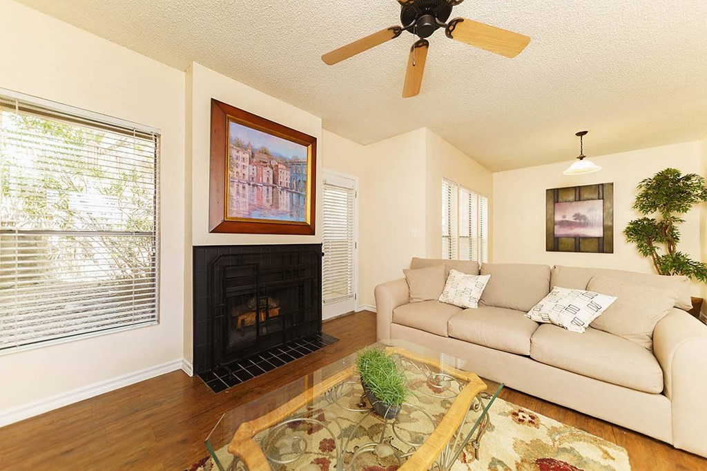 A living room with a fireplace and a painting on the wall.