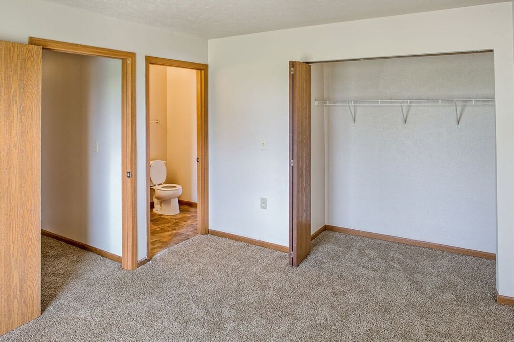 a bedroom with a toilet and a closet