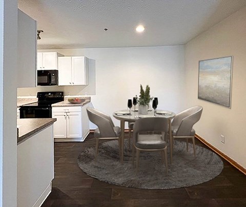 A dining room with a table set for four.