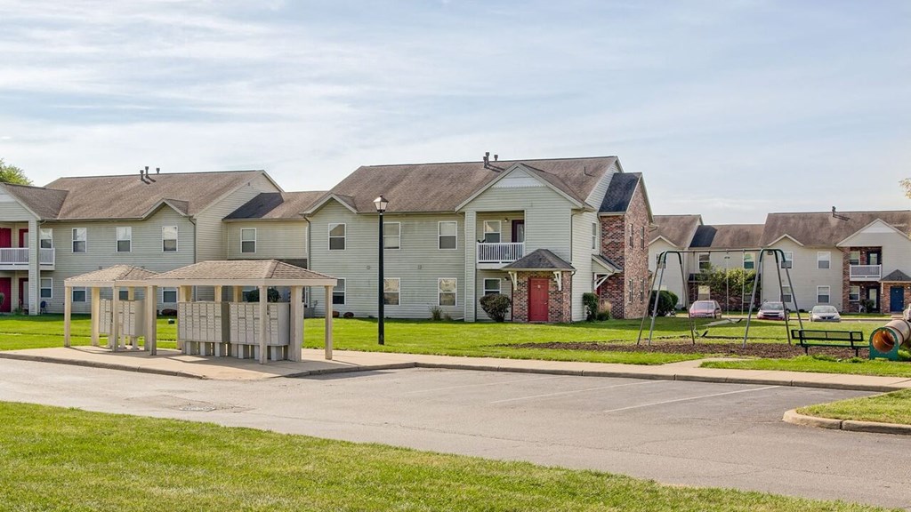 a row of houses with a playground in the foreground
