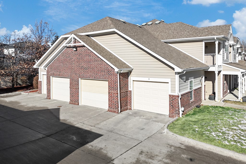 A two-car garage with a brick facade and a white garage door.