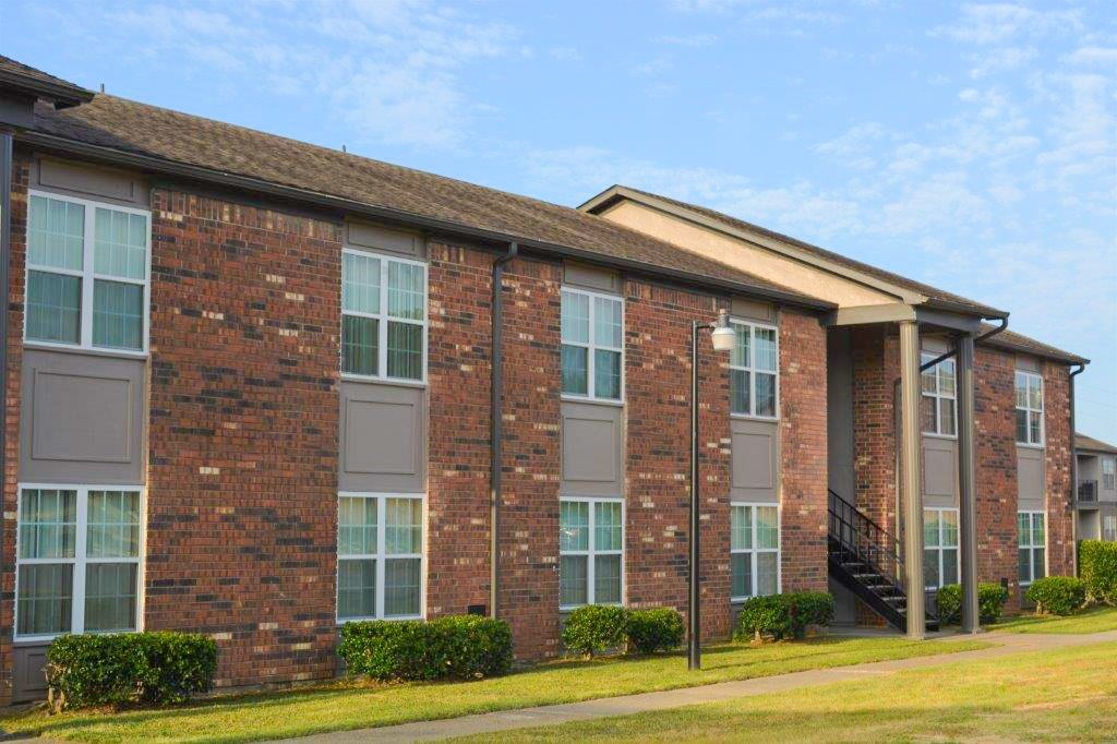 A brick building with a staircase leading to the second floor.