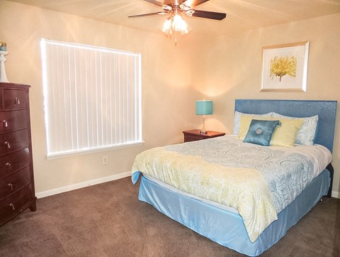 a bedroom with a bed and a ceiling fan