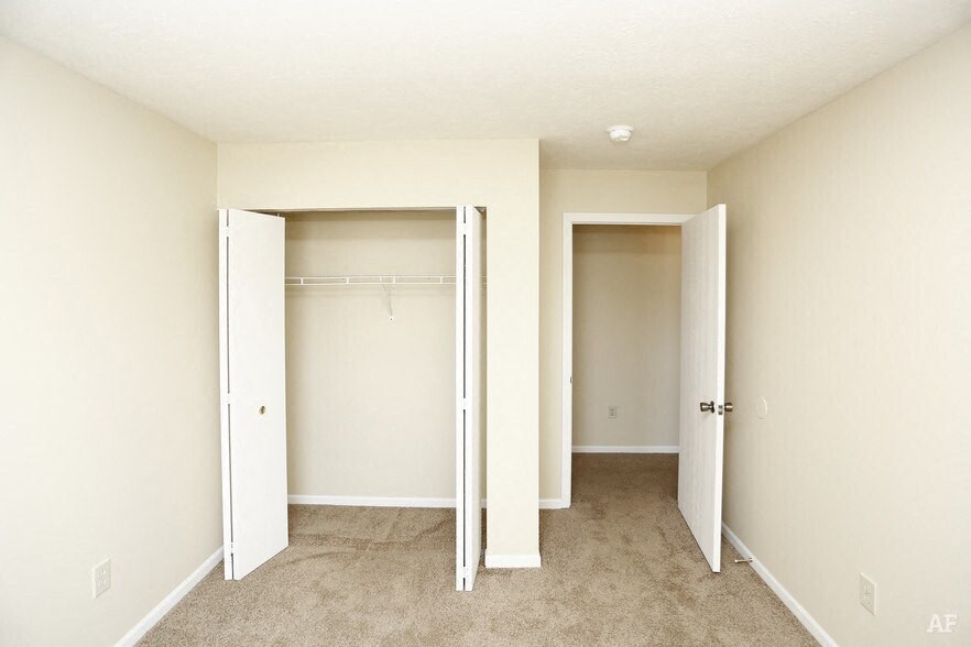 a bedroom with a closet and an open door