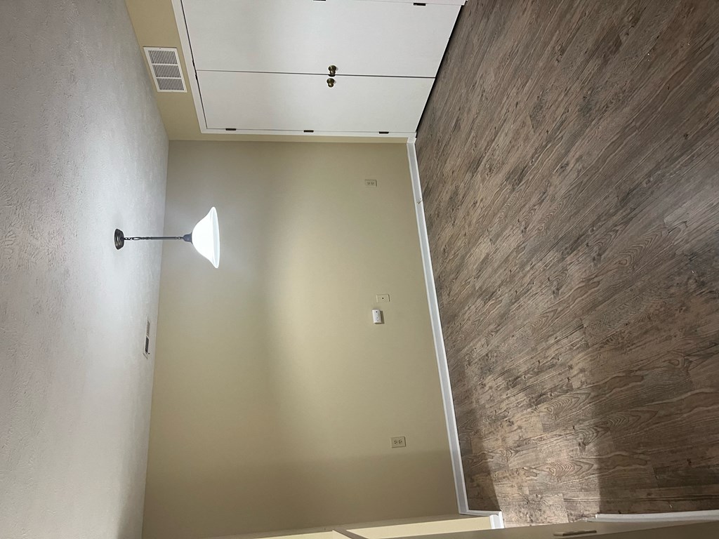 an empty room with a light on the wall