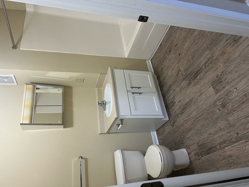 an overhead view of a bathroom with a toilet and a cabinet