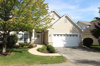 a house with a white garage door in front of it