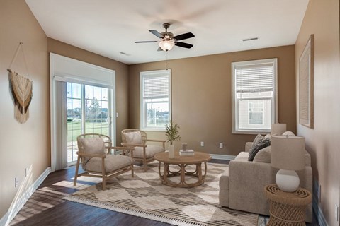A living room with a ceiling fan and a couch.