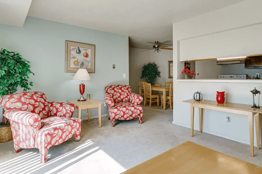 Living room with a sofa, armchair, and coffee table.
