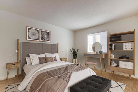 A bedroom with a large bed and a desk with a chair.