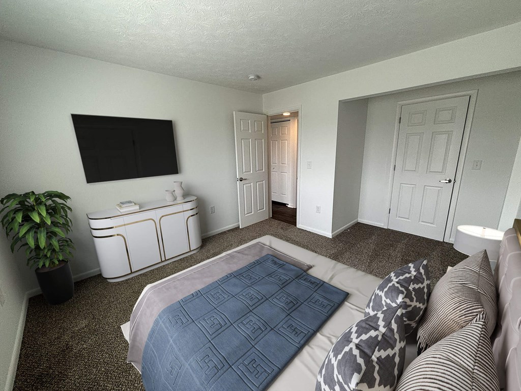 a bedroom with a large bed and a tv