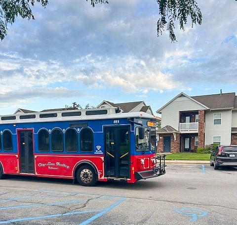 A red and blue bus with the words