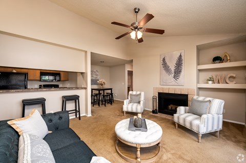 A living room with a grey couch and a white coffee table.