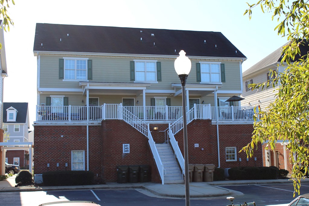 a house with a porch and a street light in front of it