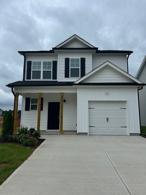 A two-story house with a white garage door.