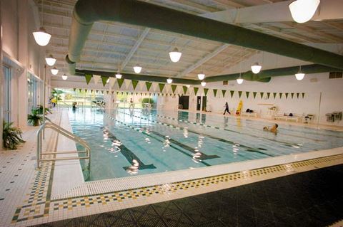 a large indoor swimming pool with people in it