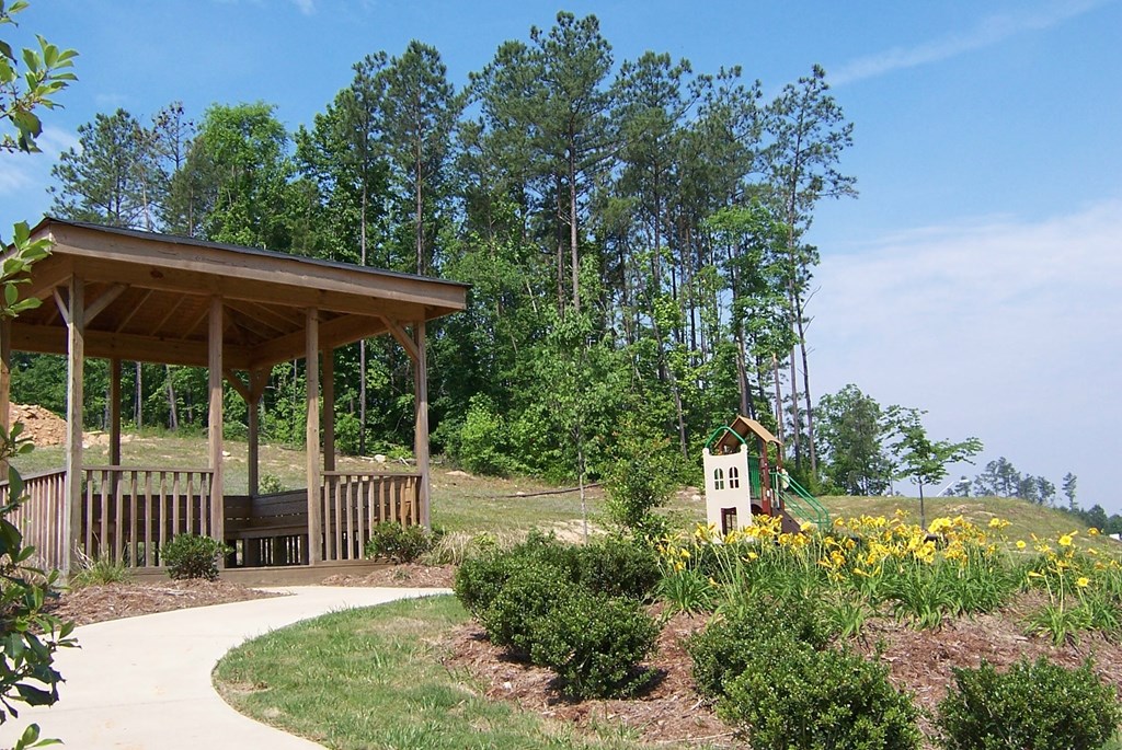a pavilion at a park with flowers and trees