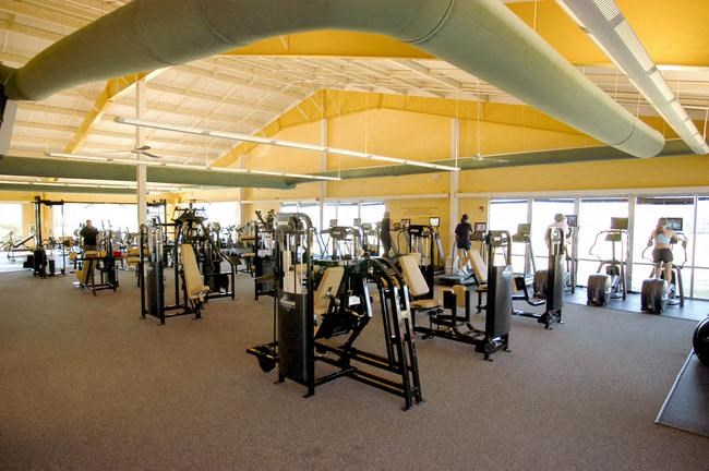 a large gym with a lot of exercise equipment