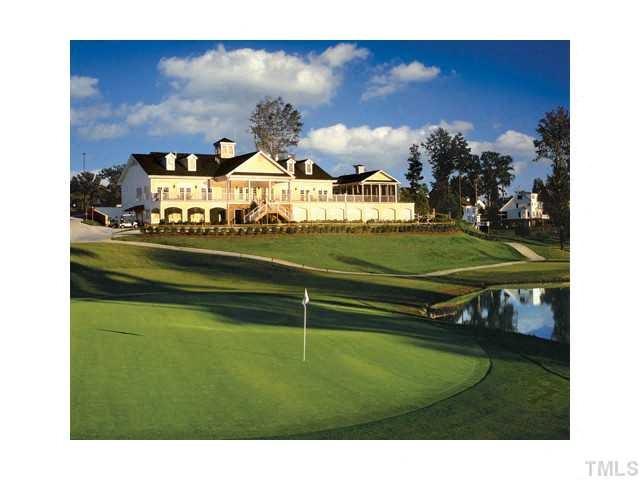 a golf course with a large building in the background