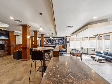 A modern living room with a dining area and a kitchen in the background.